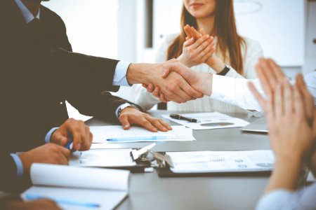 depositphotos_391331602-stock-photo-business-people-shaking-hands-at